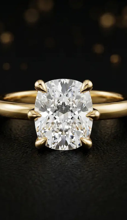 Front view of a 1.5 carat cushion cut diamond solitaire engagement ring in an 18kt yellow gold 6 claw setting by TJ Diamond