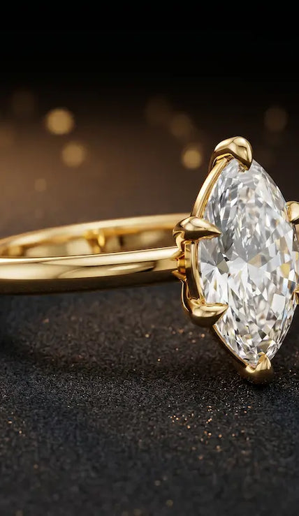 Angled side view of a 1.5 carat marquise cut diamond solitaire engagement ring in an 18kt yellow gold 6 claw setting by TJ Diamond