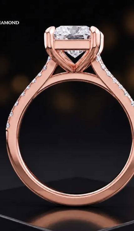 Side view of a radiant cut split shank lab-grown diamond engagement ring featuring a four-claw cathedral setting in 18kt rose gold.