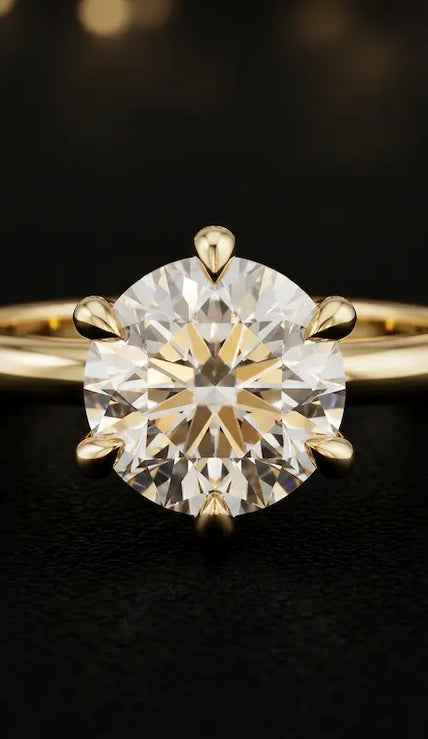Front view of a 1.5 carat round brilliant cut diamond solitaire engagement ring in an 18kt yellow gold 6 claw setting by TJ Diamond