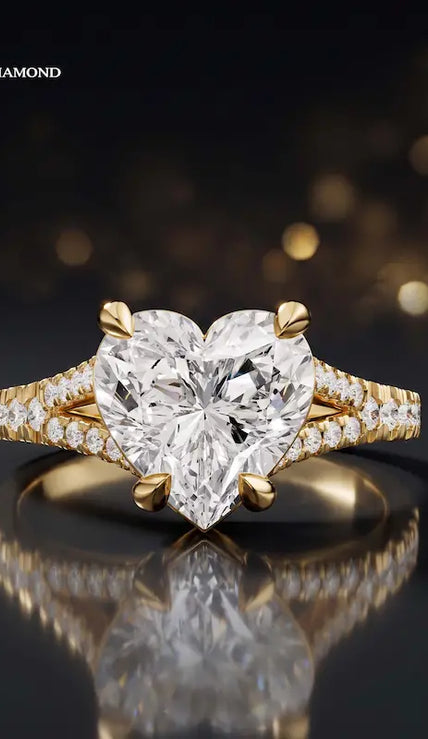 Front view of a heart cut split shank lab-grown diamond engagement ring in 18kt yellow gold.