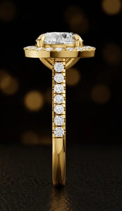 Side profile of a round cut halo lab-grown diamond engagement ring in 18kt yellow gold.