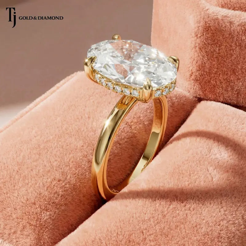Angled profile of a 4ct oval lab-grown diamond solitaire ring in 18kt yellow gold highlighting the hidden halo and elegant cathedral setting.