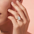 Model wearing a 4ct oval lab-grown diamond solitaire engagement ring in 18kt yellow gold.