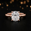 Front view of a 1.5 carat cushion cut diamond solitaire engagement ring in an 18kt rose gold 6 claw setting by TJ Diamond