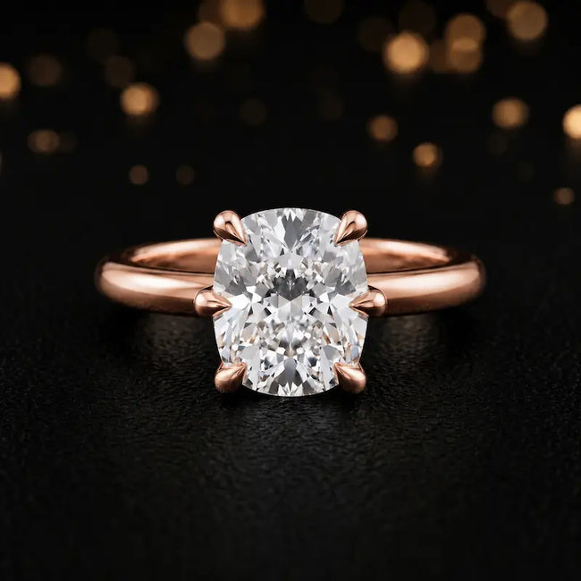Front view of a 1.5 carat cushion cut diamond solitaire engagement ring in an 18kt rose gold 6 claw setting by TJ Diamond
