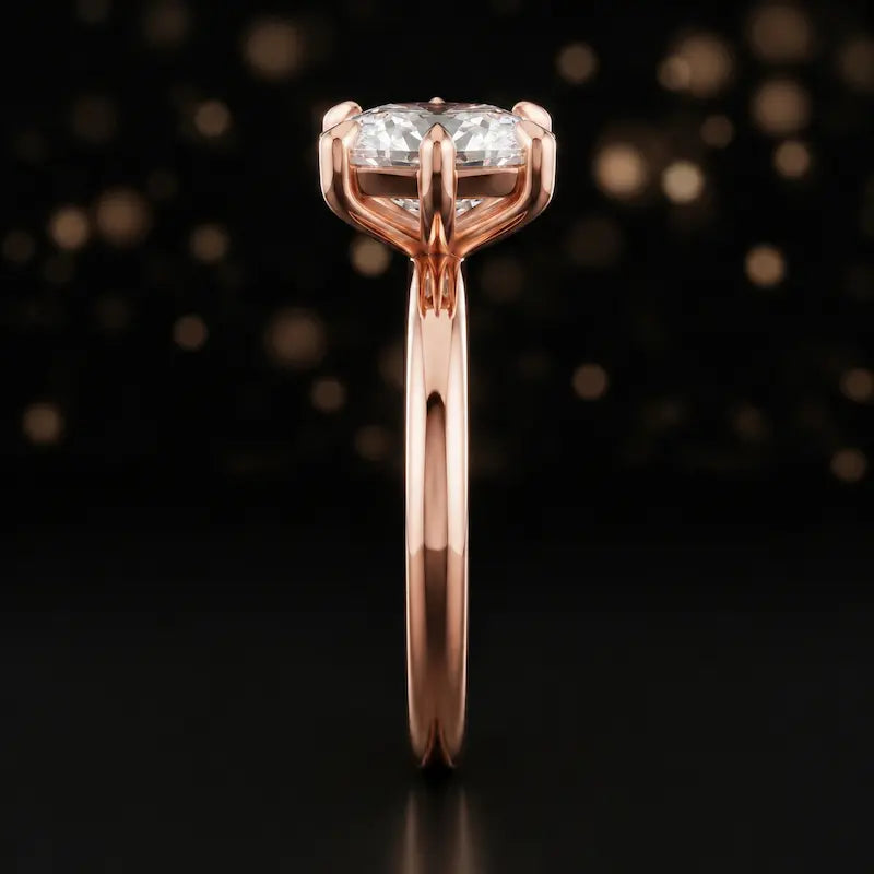 Side profile of a 1.5 carat cushion cut diamond solitaire engagement ring showing the cathedral setting and 18kt rose gold band by TJ Diamond