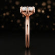 Side profile of a 1.5 carat cushion cut diamond solitaire engagement ring showing the cathedral setting and 18kt rose gold band by TJ Diamond