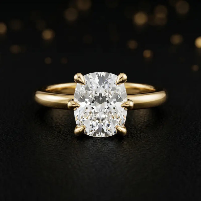 Front view of a 1.5 carat cushion cut diamond solitaire engagement ring in an 18kt yellow gold 6 claw setting by TJ Diamond