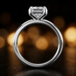 Front-on view of a 1.5 carat emerald cut diamond solitaire engagement ring showing the full 18kt white gold band and 6 claw cathedral setting by TJ Diamond