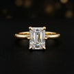 Front view of a 1.5 carat emerald cut diamond solitaire engagement ring in an 18kt yellow gold 6 claw setting by TJ Diamond