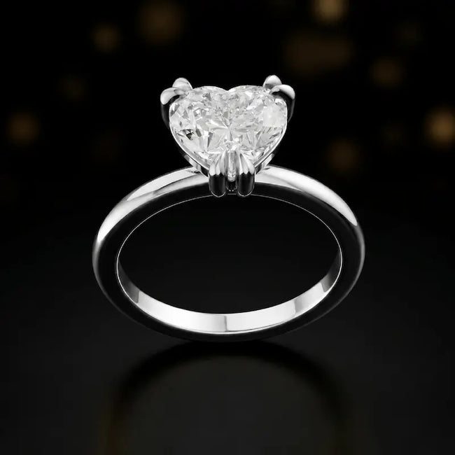 Front view of a 1.5 carat heart cut diamond solitaire engagement ring in an 18kt white gold 6 claw setting by TJ Diamond