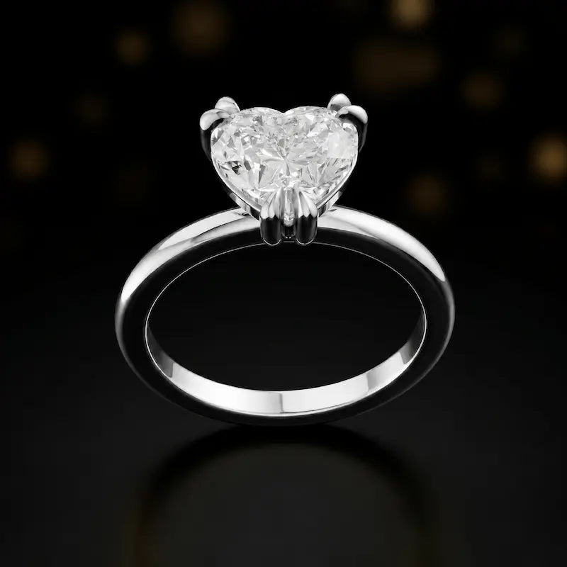 Front view of a 1.5 carat heart cut diamond solitaire engagement ring in an 18kt white gold 6 claw setting by TJ Diamond