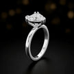 Front-on view of a 1.5 carat heart cut diamond solitaire engagement ring showing the full 18kt white gold band and 6 claw cathedral setting by TJ Diamond
