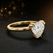 Angled side view of a 1.5 carat heart cut diamond solitaire engagement ring in an 18kt yellow gold 6 claw setting by TJ Diamond