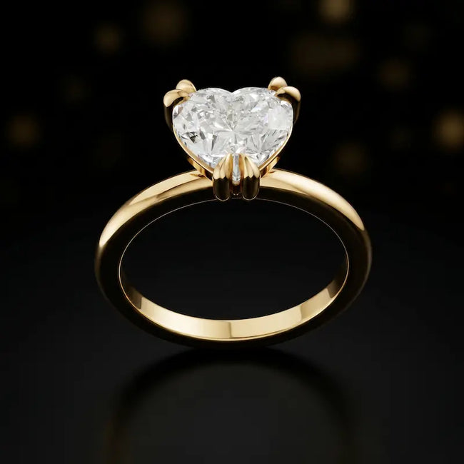 Front view of a 1.5 carat heart cut diamond solitaire engagement ring in an 18kt yellow gold 6 claw setting by TJ Diamond