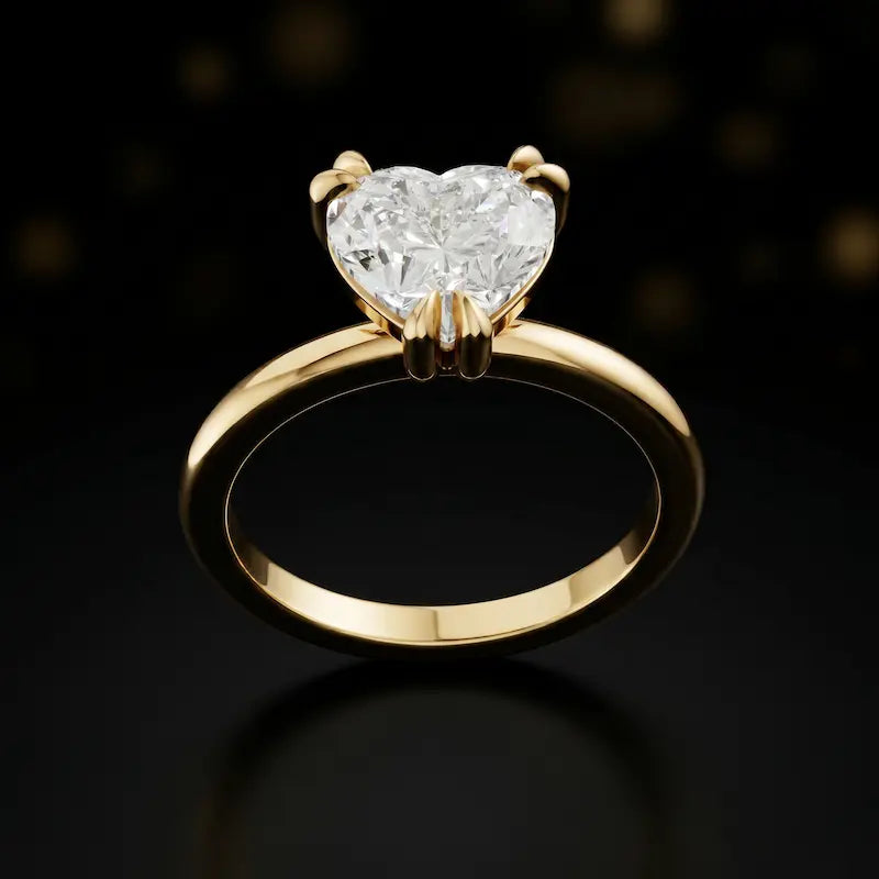 Front view of a 1.5 carat heart cut diamond solitaire engagement ring in an 18kt yellow gold 6 claw setting by TJ Diamond