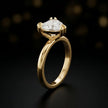 Front-on view of a 1.5 carat heart cut diamond solitaire engagement ring showing the full 18kt yellow gold band and 6 claw cathedral setting by TJ Diamond