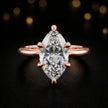 Front view of a 1.5 carat marquise cut diamond solitaire engagement ring in an 18kt rose gold 6 claw setting by TJ Diamond