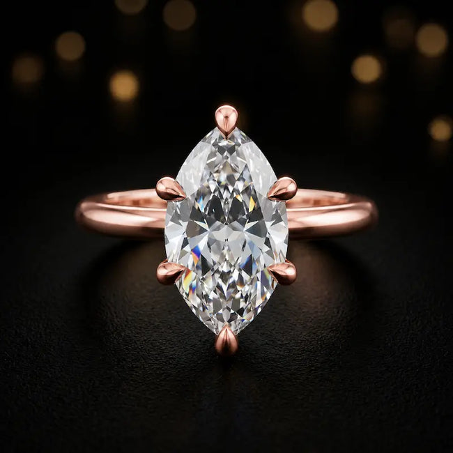 Front view of a 1.5 carat marquise cut diamond solitaire engagement ring in an 18kt rose gold 6 claw setting by TJ Diamond