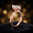 Angled side view of a 1.5 carat marquise cut diamond solitaire engagement ring in an 18kt rose gold 6 claw setting by TJ Diamond