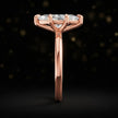 Side profile of a 1.5 carat marquise cut diamond solitaire engagement ring showing the cathedral setting and 18kt rose gold band by TJ Diamond