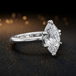 Front-on view of a 1.5 carat marquise cut diamond solitaire engagement ring showing the full 18kt white gold band and 6 claw cathedral setting by TJ Diamond