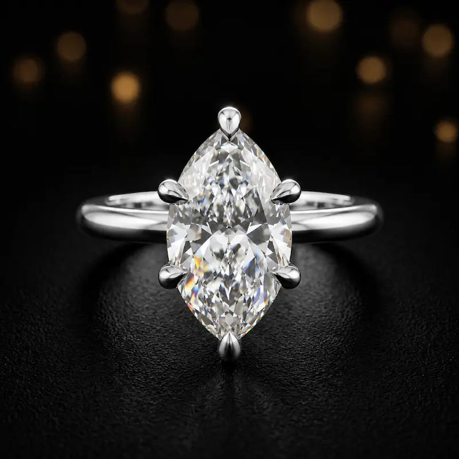 Front view of a 1.5 carat marquise cut diamond solitaire engagement ring in an 18kt white gold 6 claw setting by TJ Diamond