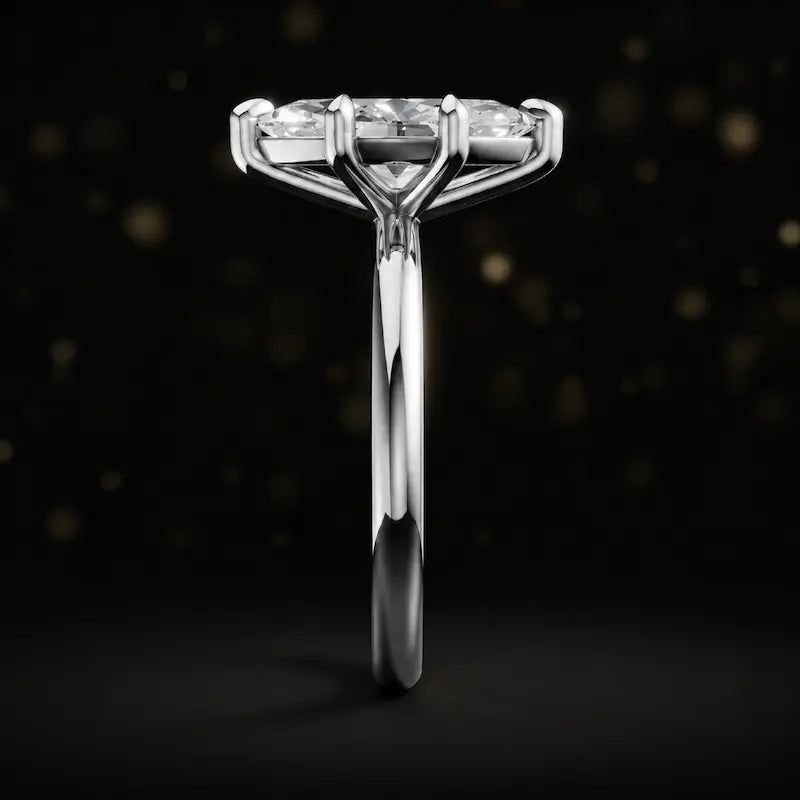 Side profile of a 1.5 carat marquise cut diamond solitaire engagement ring showing the cathedral setting and 18kt white gold band by TJ Diamond