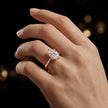 1.5 carat oval cut diamond solitaire engagement ring in an 18kt rose gold 6 claw setting worn on a hand, by TJ Diamond