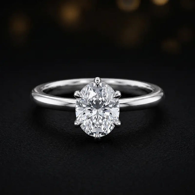 Front view of a 1.5 carat oval cut diamond solitaire engagement ring in an 18kt white gold 6 claw setting by TJ Diamond