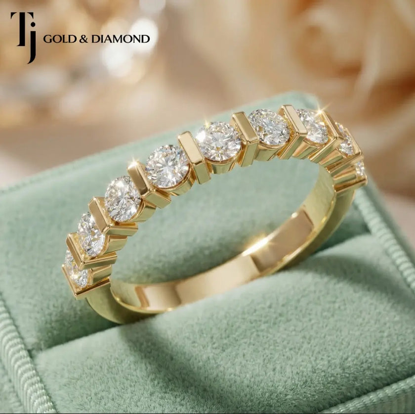 Top view of Bar Half Eternity diamond wedding band in 18kt yellow gold, showing round brilliant diamonds secured between vertical gold bars