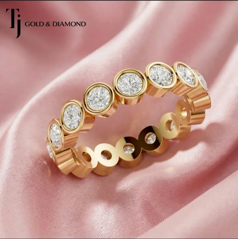 Bezel setting full eternity diamond wedding band in 18kt yellow gold with round brilliant lab-grown diamonds.