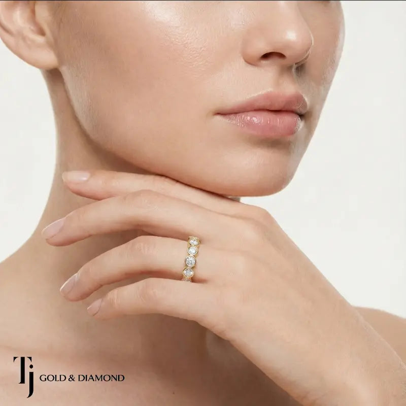Model wearing a bezel setting full eternity diamond wedding band in 18kt yellow gold with round brilliant lab-grown diamonds.