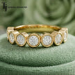 Close Up view of Bezel Setting Half Eternity diamond wedding band in 18kt yellow gold.