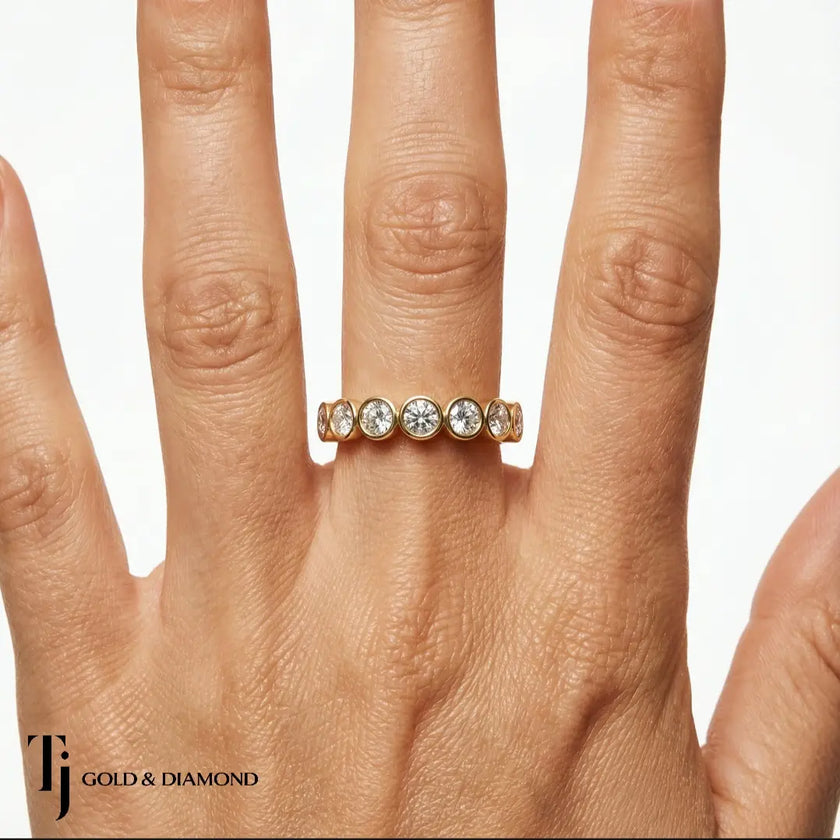 Bezel Setting Half Eternity diamond wedding band in 18kt yellow gold, worn on hand