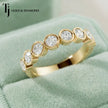 Close Up View of Bezel Setting Half Eternity diamond wedding band in 18kt yellow gold.