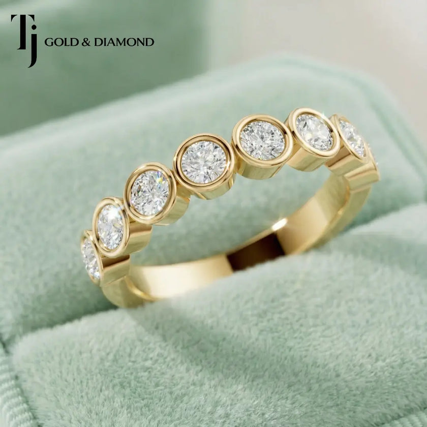 Close Up View of Bezel Setting Half Eternity diamond wedding band in 18kt yellow gold.