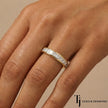 Channel setting full eternity diamond wedding band in 18kt yellow gold worn on hand with princess cut lab-grown diamonds.