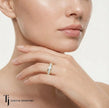 Model wearing a channel setting full eternity diamond wedding band in 18kt yellow gold with princess cut lab-grown diamonds.