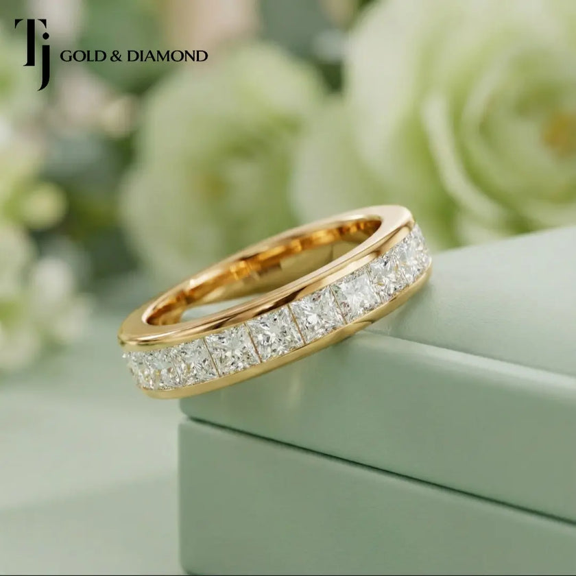 Angled view of Channel Half Eternity diamond wedding band in 18kt yellow gold, princess cut diamonds set in channel