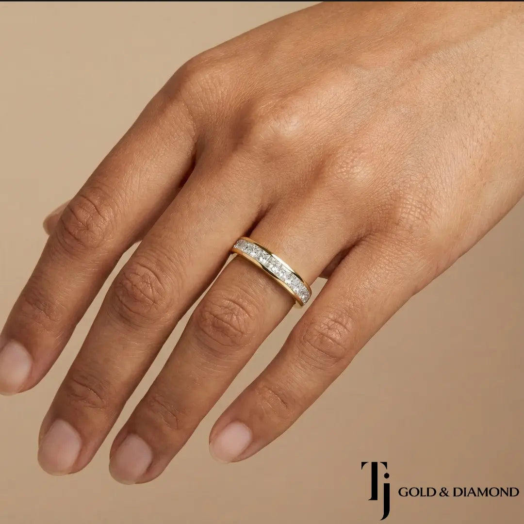 Channel Half Eternity diamond wedding band worn on hand, 18kt yellow gold with princess cut lab-grown diamonds