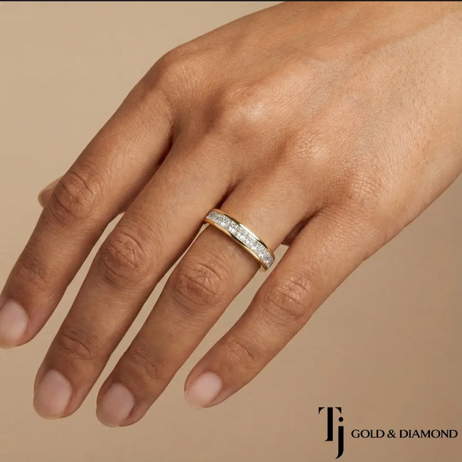 Channel Half Eternity diamond wedding band worn on hand, 18kt yellow gold with princess cut lab-grown diamonds