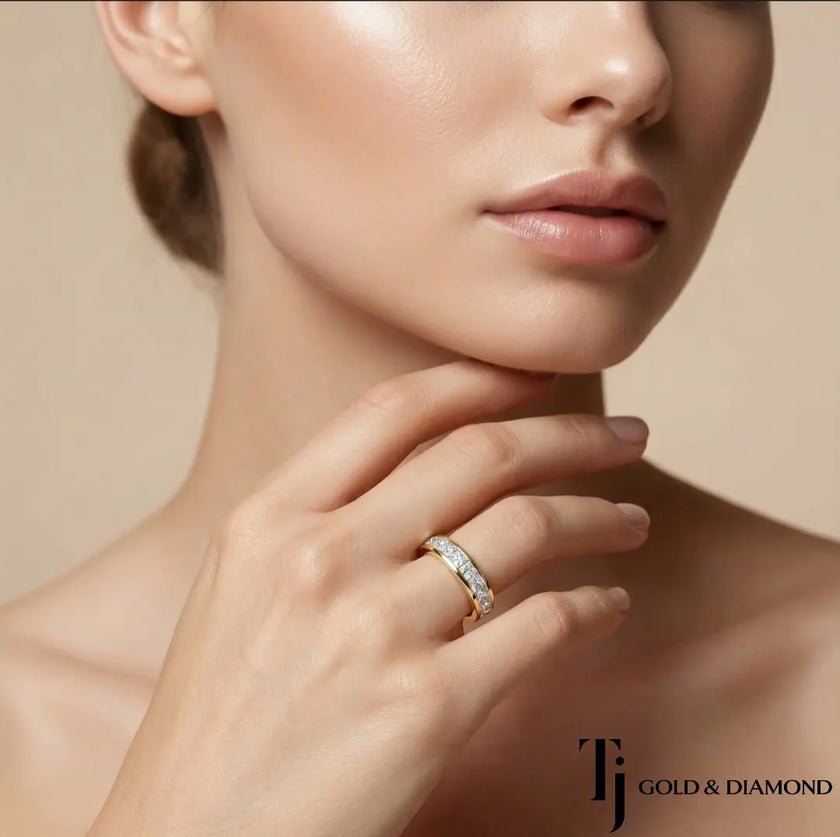 Model wearing Channel Half Eternity diamond wedding band in 18kt yellow gold, close-up lifestyle shot