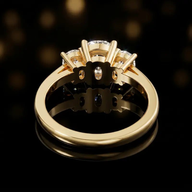 Back view of a cushion-cut three-stone lab-grown diamond ring in 18ct yellow gold, showing the open basket settings.