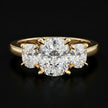 Front view of a cushion-cut lab-grown diamond trilogy engagement ring in 18ct yellow gold with matching cushion-cut side diamonds.