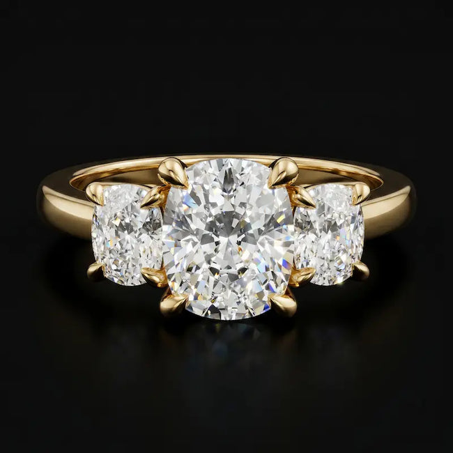 Front view of a cushion-cut lab-grown diamond trilogy engagement ring in 18ct yellow gold with matching cushion-cut side diamonds.