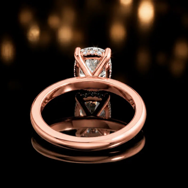 Back view of 4-claw cushion cut engagement ring with hidden halo in 18kt rose gold