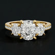 Front view of a cushion cut three-stone lab-grown diamond engagement ring in 18kt yellow gold with diamond shoulders