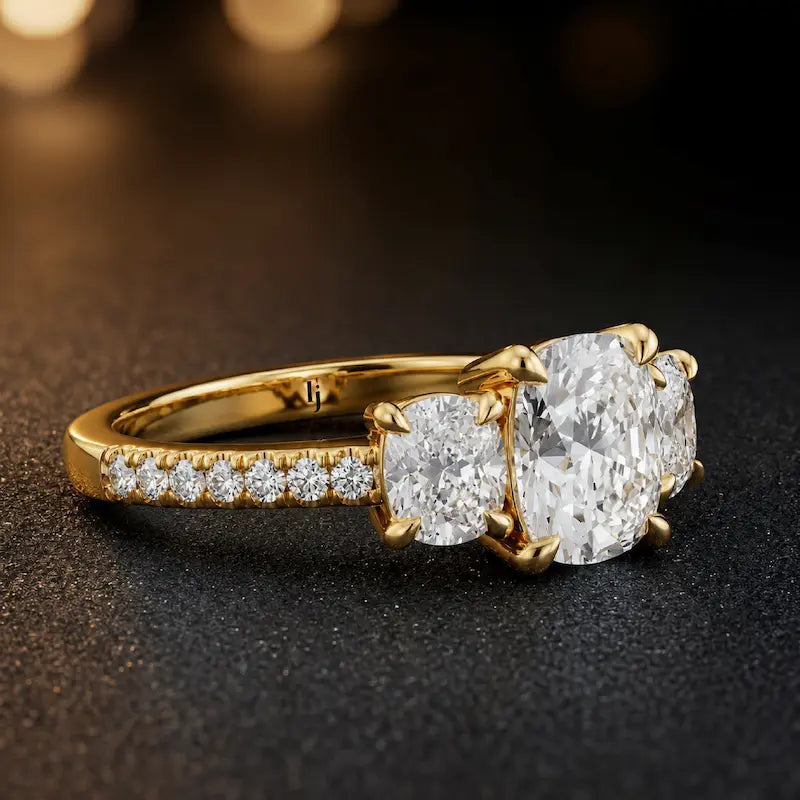Side view of a cushion cut three-stone lab-grown diamond engagement ring in 18kt yellow gold with diamond shoulders